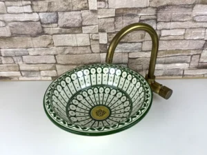 Artisan Moroccan sink with blue, green, and orange floral motifs
