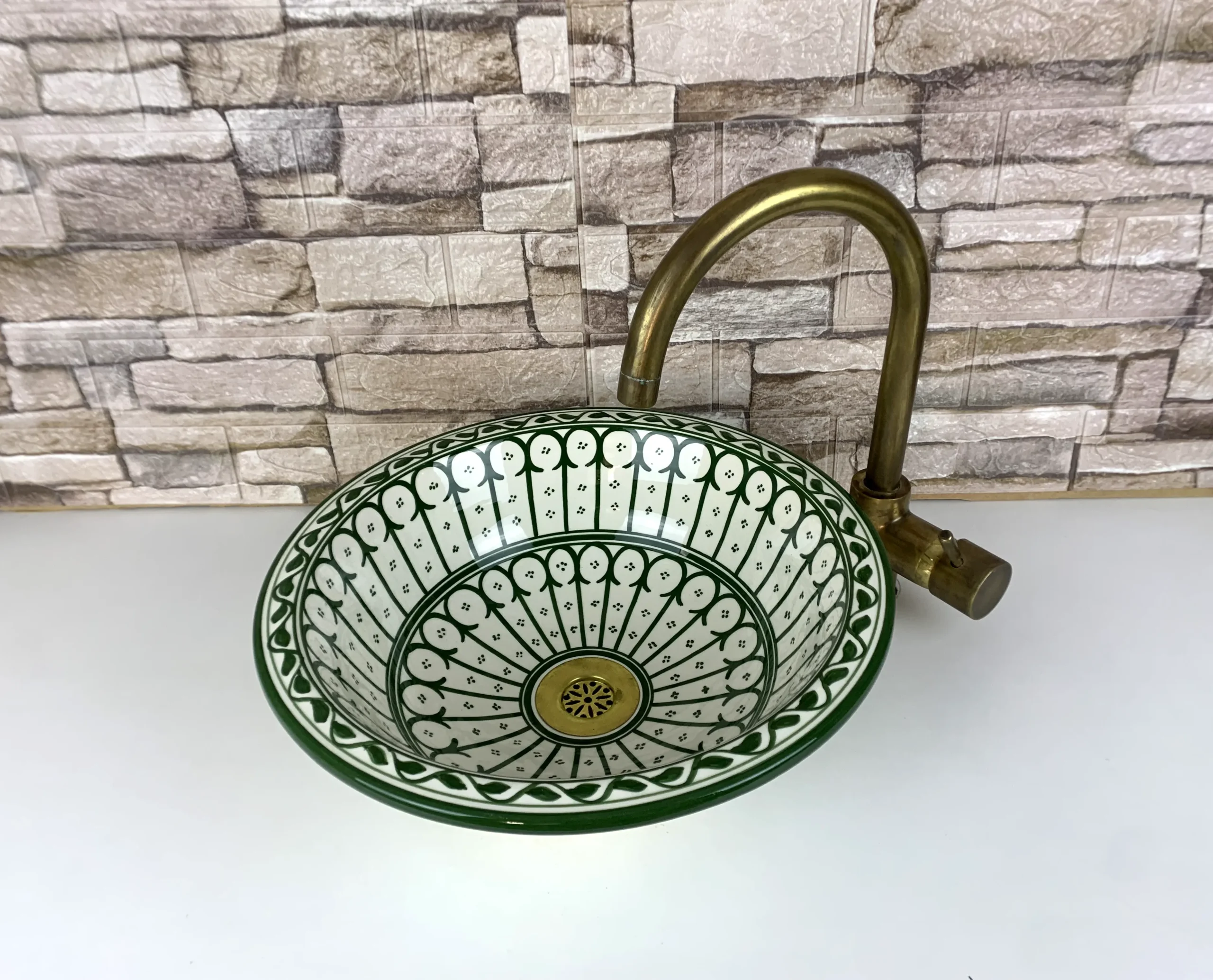 Artisan Moroccan sink with blue, green, and orange floral motifs