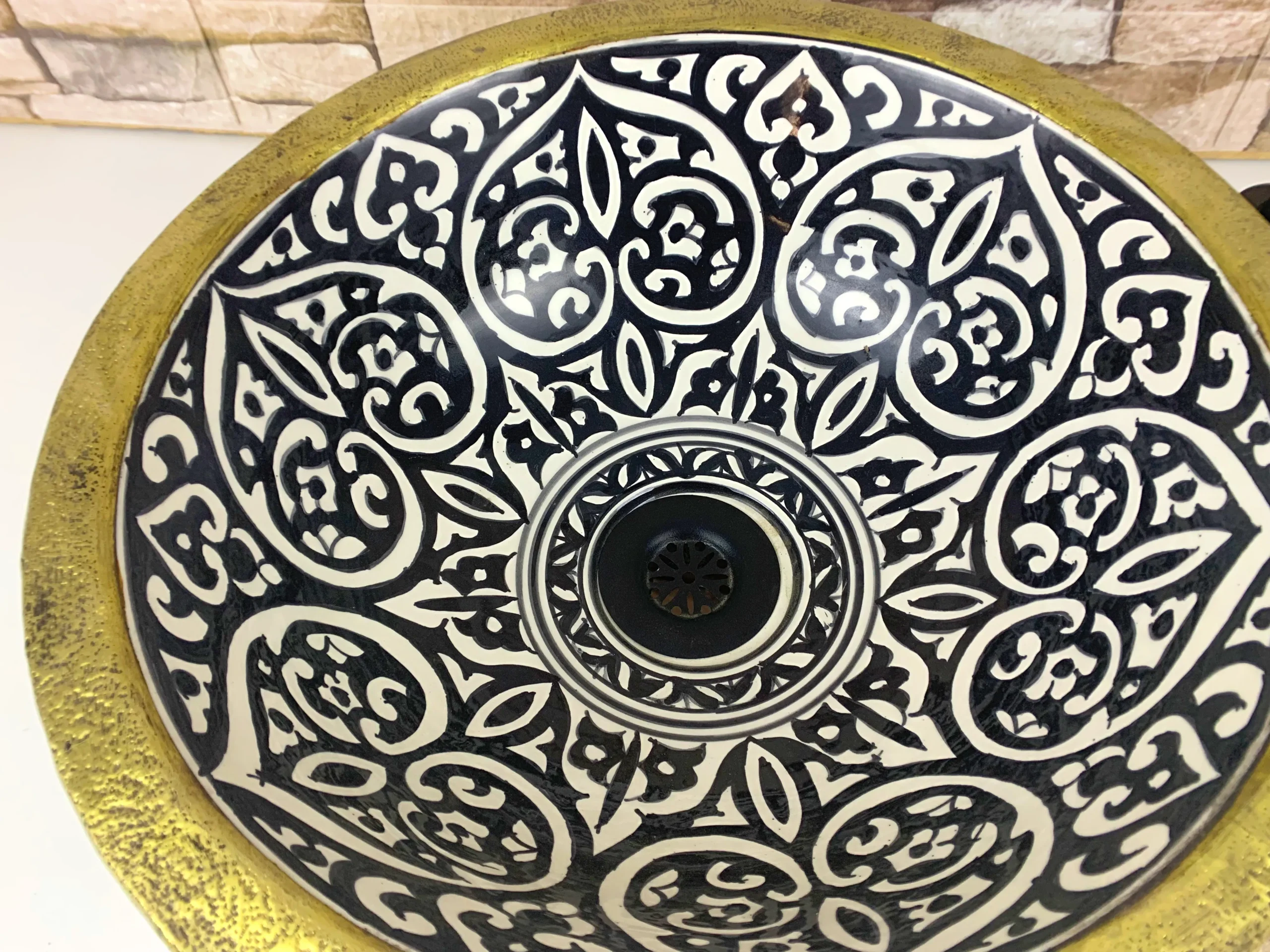 Moroccan black and white ceramic vessel sink with geometric pattern