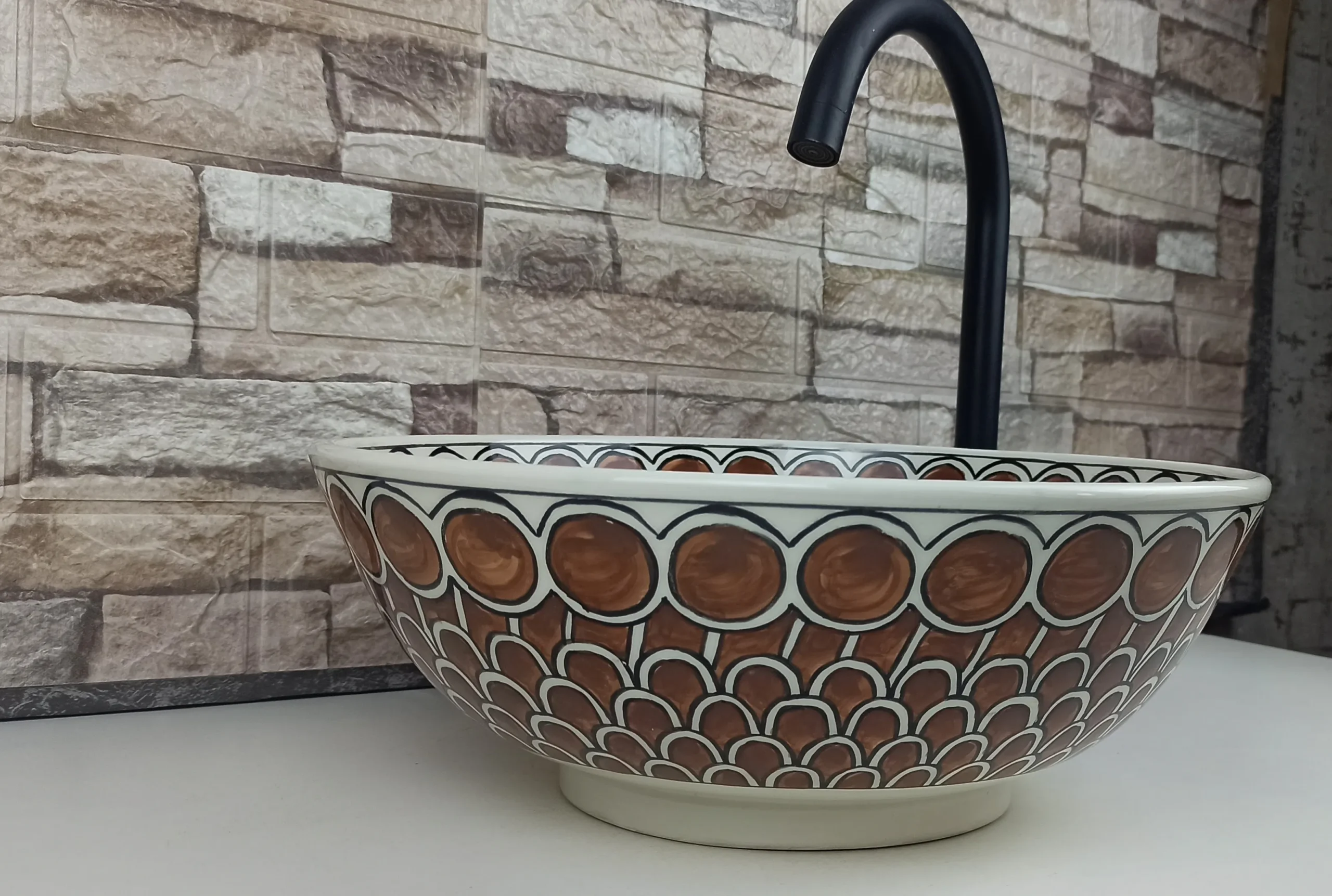 Hand-painted Moroccan vessel sink with warm earthy tones